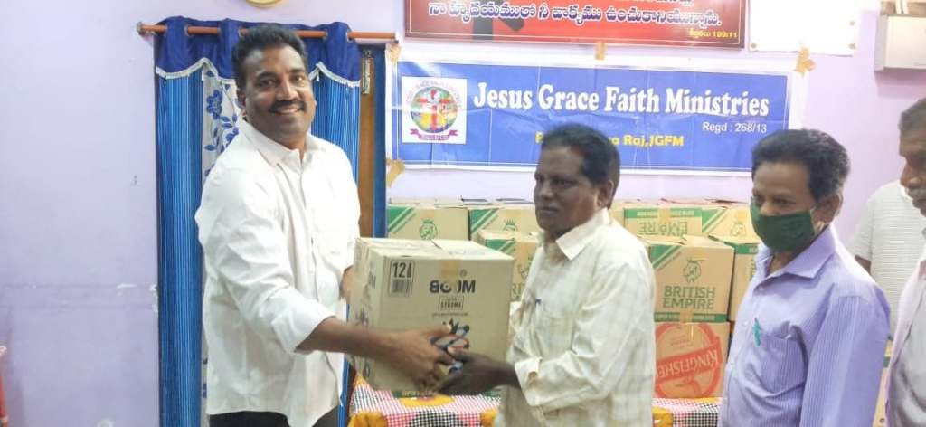 This image has an empty alt attribute; its file name is dr.-satyaraj-handing-out-food.jpg